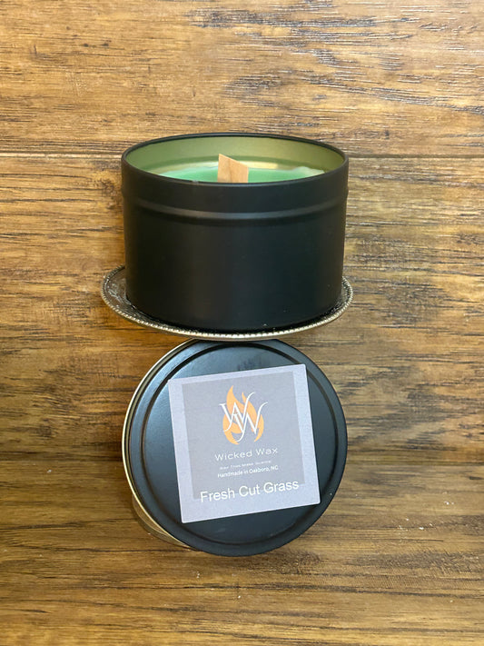 This 6oz black tin canister has been filled with the fresh scent of cut grass, and a wooden wick.